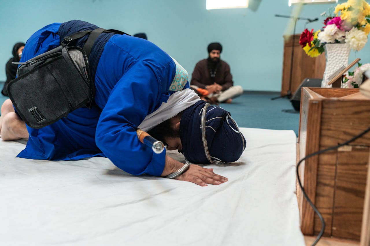 Man Prostrating while Praying inside Gurdwara Sahib